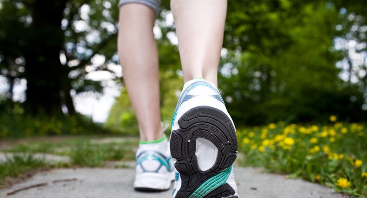 0349_153170448 image of woman's lower legs in sneakers, walking away